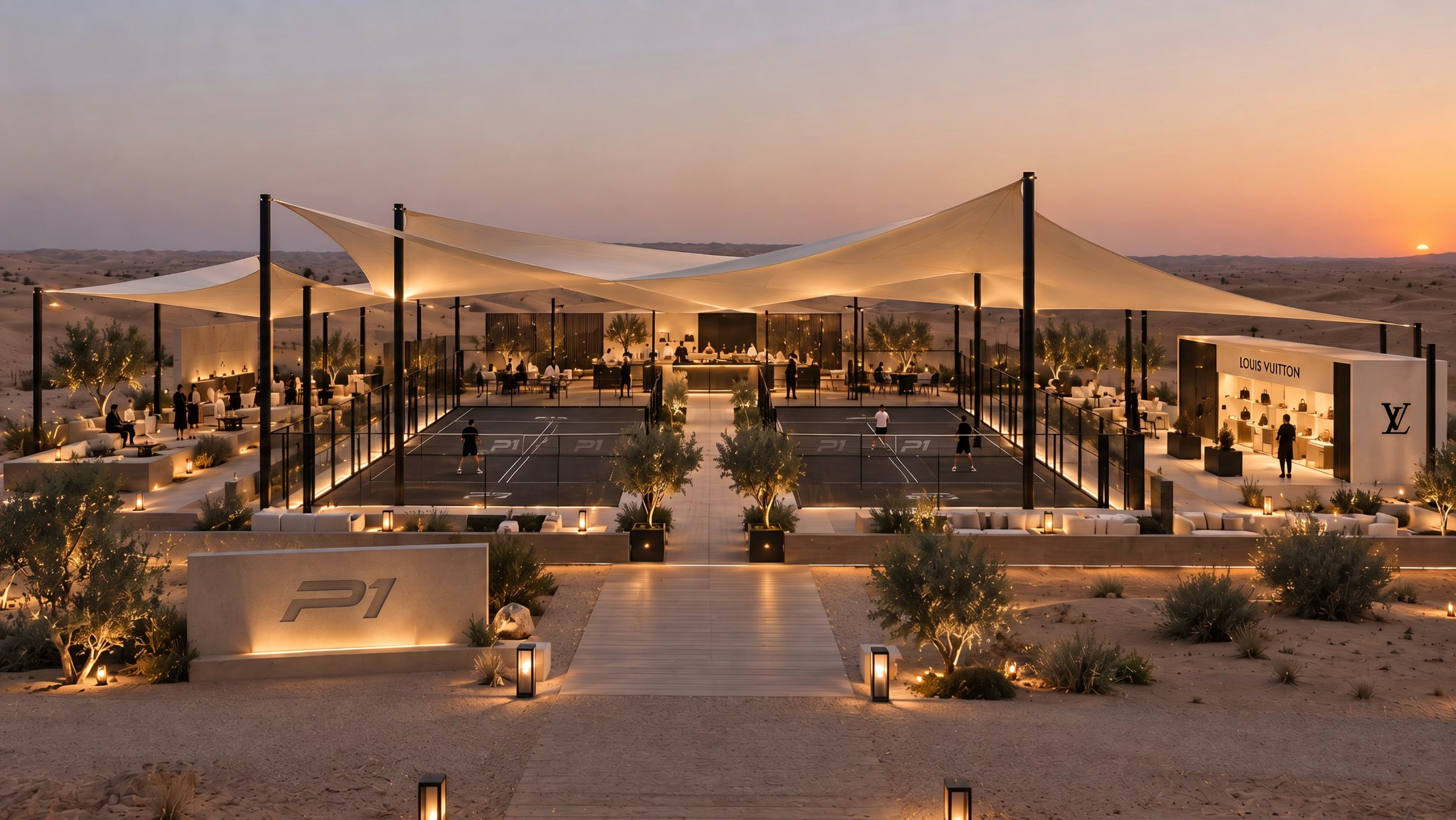 Two courts under tensile shade sails in the desert at dusk, olive trees and a P1 stone sign at the entrance